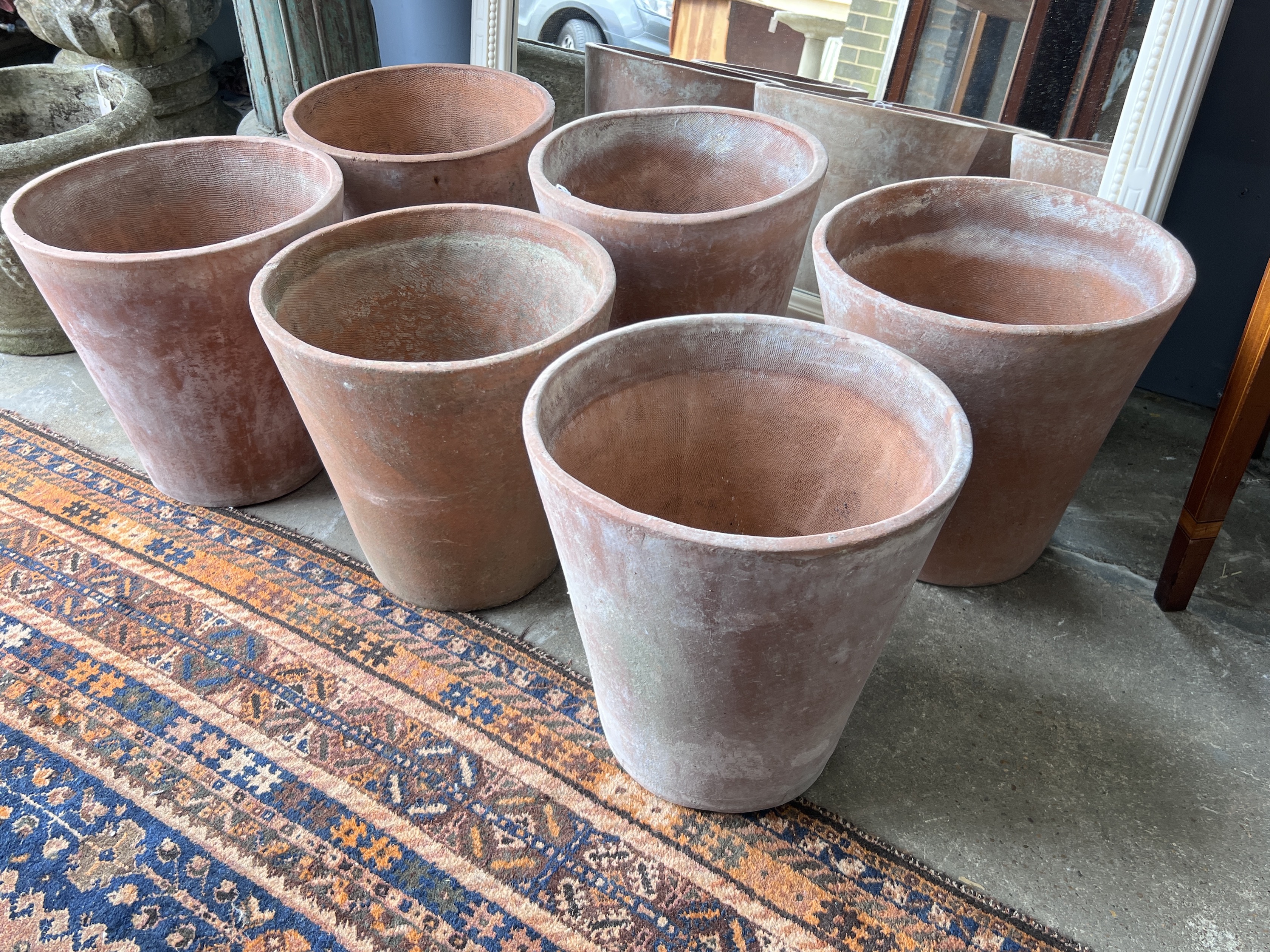 A set of six circular terracotta planters, diameter 35cm, height 36cm